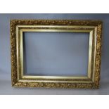 A 19TH CENTURY GOLD FRAME WITH LEAF DESIGN AND INTEGRAL GOLD SLIP, frame W 11 cm, rebate 65 x 45 cm