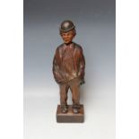 A BLACK FOREST CARVED SOFTWOOD 'WHISTLING FIGURE', circa 1930, in the form of a man with his hands