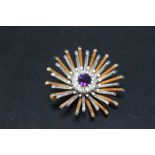 A HALLMARKED WHITE AND YELLOW GOLD DIAMOND AND AMETHYST SET SUNBURST BROOCH, hallmarks indistinct