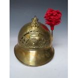 A 19TH CENTURY FRENCH BRASS FIREMANS HELMET, with Sapeurs Pompiere Montrevil badge and side plume