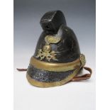 A VICTORIAN MERRYWEATHER LEATHER FIREMANS HELMET, with brass banding and head badge