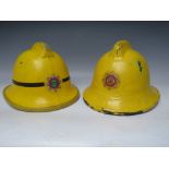 TWO STAFFORDSHIRE CORK BASE FIRE HELMETS, small size dated 1976 and 1985