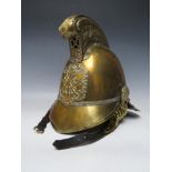 A 19TH CENTURY MERRYWEATHER BRASS FIREMANS HELMET, standard issue with chin strap