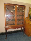 AN ANTIQUE MAHOGANY GLAZED DISPLAY CABINET RAISED ON BALL AND CLAW FEET H-164 W-108 CM