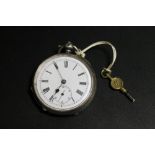 AN ANTIQUE SILVER CASED POCKET WATCH WITH KEY