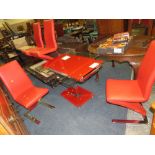 A MODERN GLASS KITCHEN TABLE WITH FOUR RED CHAIRS