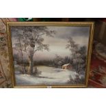 A FRAMED OIL OF A LAKESIDE WINTER SCENE