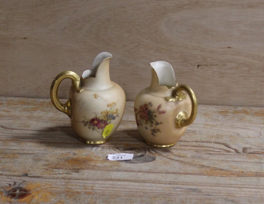 A ROYAL WORCESTER SMALL BLUSH IVORY JUG TOGETHER WITH ANOTHER - THE SECOND HAVING DAMAGES
