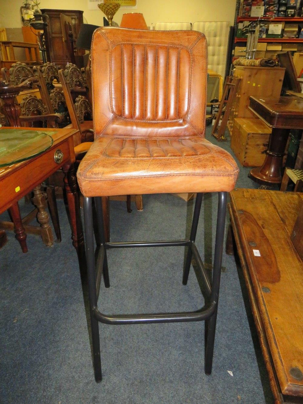 A TAN LEATHER BAR STOOL