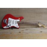 A RED THREE SINGLE COIL PICK UP FENDER STYLE ELECTRIC GUITAR WITH WHAMMY BAR