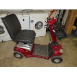 A RED MOBILITY SCOOTER WITH KEY AND CHARGER