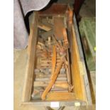 A WOODEN CRATE OF VINTAGE WOODWORKING PLANES