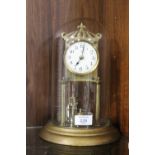 AN EARLY 20TH CENTURY BRASS CASED TORSION CLOCK WITH DISK PENDULUM