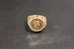 A HALLMARKED 9 CARAT GOLD RING SET WITH A 1 TALLAR COIN DATED 1853