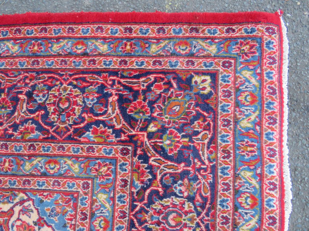 A LARGE RED / BLUE GROUND CARPET, APPROX 389 X 297 CM - WEAR THROUGHOUT - Image 2 of 8