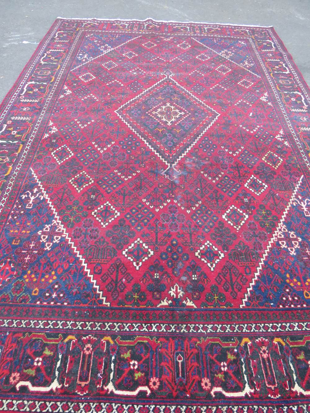 A LARGE IRANIAN CARPET - NAVY GROUND, APPROX 330 X 215 CM - WEAR THROUGHOUT