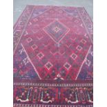 A LARGE IRANIAN CARPET - NAVY GROUND, APPROX 330 X 215 CM - WEAR THROUGHOUT