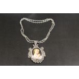 A LARGE ANTIQUE FILIGREE SILVER PENDANT AND CHAIN CONTAINING MINIATURE