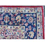 A LARGE RUG, CREAM GROUND WITH RED AND BLUE, APPROX 368 X 270 - WEAR THROUGHOUT