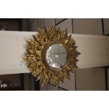 A ROUND STAR BURST MIRROR WITH GILT FRAME