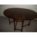 AN OAK DROP LEAF DINING TABLE