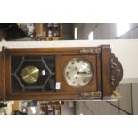 A WOODEN CASED CLOCK WITH KEY