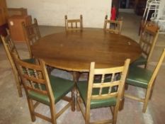 A SOLID OAK DROP LEAF DINING SET AND 8 CHAIRS