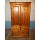 A SOLID PINE DOUBLE MANS WARDROBE WITH DRAWERS IN DUCAL STYLE