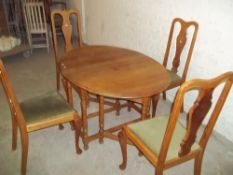 AN OAK DROP LEAF DINING SET WITH TABLE AND 4 CHAIRS