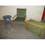 A FIRESIDE CHAIR, A WICKER OTTOMAN AND A LOOM SIDE TABLE