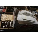 A BOX OF LINEN AND A CASED SET OF EPNS SPOONS