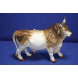 A 19TH CENTURY PORCELAIN MODEL OF A BULL, WITH BLUE CROSSED SWORDS MARK, POSSIBILY MEISSEN L 36 CM