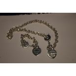A SILVER NECKLACE AND BRACELET WITH HEART PENDANTS