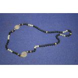 A CHINESE JADE TYPE BEAD NECKLACE WITH 2 CHARACTER PANELS