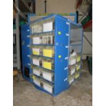 A ROTATING STORAGE CAROUSEL CONTAINING VARIOUS SYRINGES, ROTARY CUTTERS, BUTTONS ETC