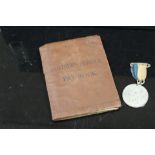 AN ARMY SOLDIERS SERVICE AND PAY BOOK TOGETHER WITH A MEDAL