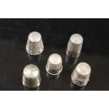 FIVE WHITE METAL THIMBLES