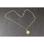 A 10K REMBRANT NIAGRA FALLS MAPLE LEAF PENDANT ON CHAIN STAMPED 9K - APPROX COMBINED WEIGHT 2.6 G