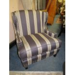 A MODERN STRIPED UPHOLSTERED ARMCHAIR