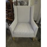A LARGE MODERN STRIPED UPHOLSTERED ARMCHAIR