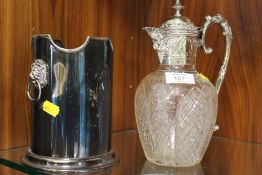 AN ANTIQUE SILVER PLATED CUT GLASS CLARET JUG TOGETHER WITH A LION MASK BOTTLE HOLDER (2)