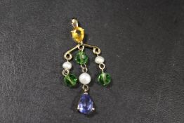 A GILT METAL PENDANT SET WITH SEED PEARLS AND COLOURED STONES