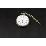 AN ANTIQUE SILVER CASED POCKET WATCH WITH KEY