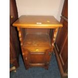 A SMALL REPRODUCTION OAK BEDSIDE CUPBOARD