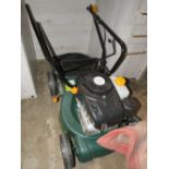 A PETROL MOWER WITH BOX