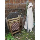 A TEAK PATIO TABLE WITH FOUR CHAIRS AND A PARASOL