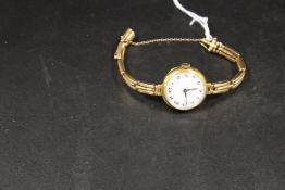 A HALLMARKED 18CT GOLD LADIES WRISTWATCH WITH ENGRAVING TO REVERSE OF BACK CASING, ON UNMARKED