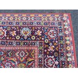 A LARGE CARPET - RUST / TERRACOTTA GROUND WITH NAVY / YELLOW PATTERN, APPROX 365 X 253 CM - WEAR