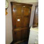 A WARING & GILLOW OAK FLOORSTANDING CORNER CUPBOARD