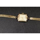 A LADIES CYMA CYMAFLEX LADIES WRIST WATCH ON A HALLMARKED 9CT GOLD TWO STRAND SNAKE LINK BRACELET